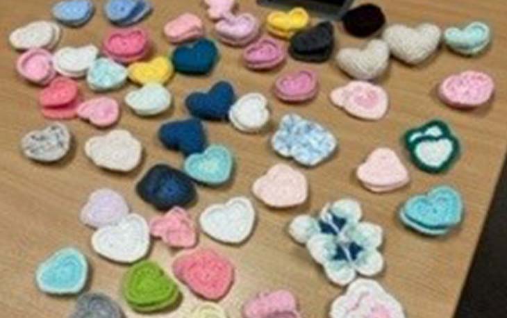 Picture of various crocheted hearts in different colours.